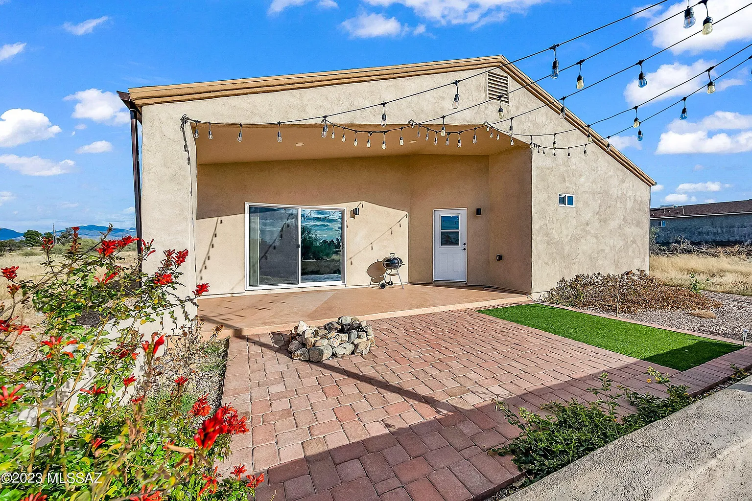 Modern custom home with covered patio and outdoor lighting in Tucson Arizona